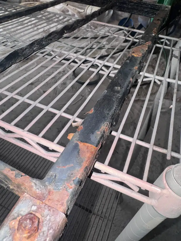 Rusted, flaking steel frame corner before sandblasting at Dyarman's in Carlisle, PA