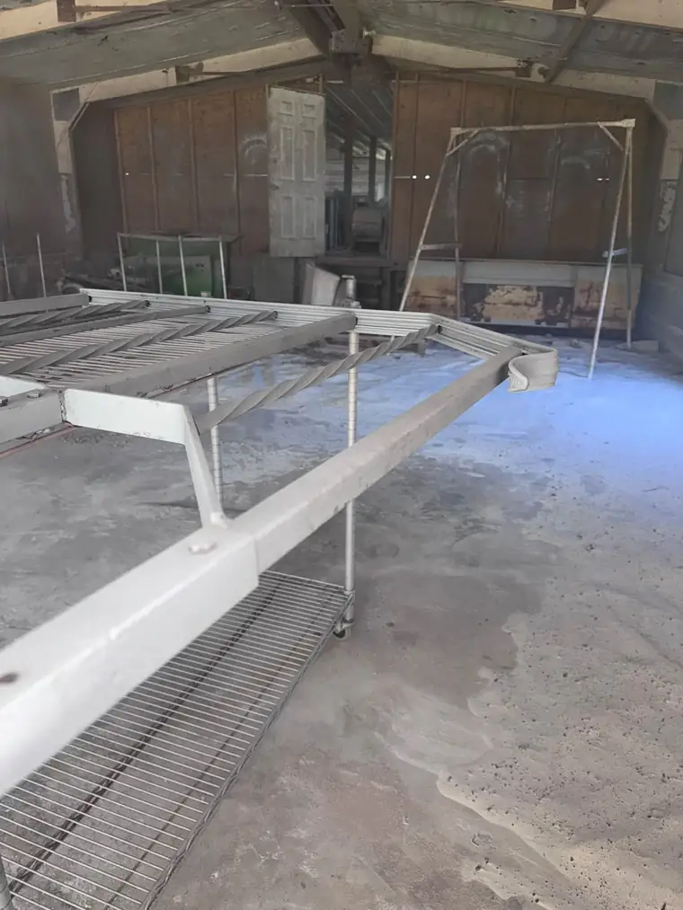 The same frame end after sandblasting, clean gray steel