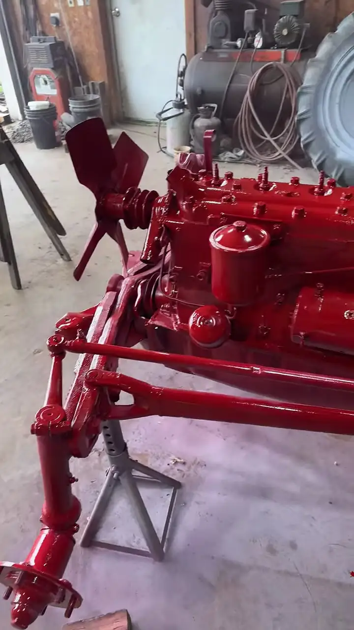 Older tractor freshly painted red during restoration